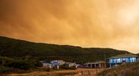 Smoke swirls in the sky at Trial Harbour from nearby bushfires.