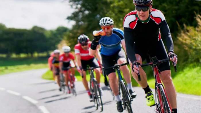 Can large groups of cyclists ride side-by-side and proceed as one at stop signs?
