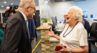 Prime Minister Anthony Albanese shares a joke with 96-year-old Eve Cazalet at Burwood Healthcare.