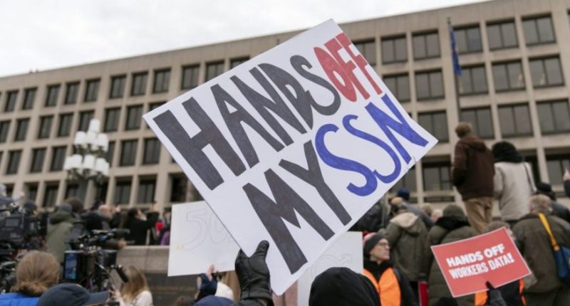 People protest during a rally against Elon Musk outside the U.S. Department of Labor in Washington, Wednesday, Feb. 5, 2025. (AP Photo/Jose Luis Magana)