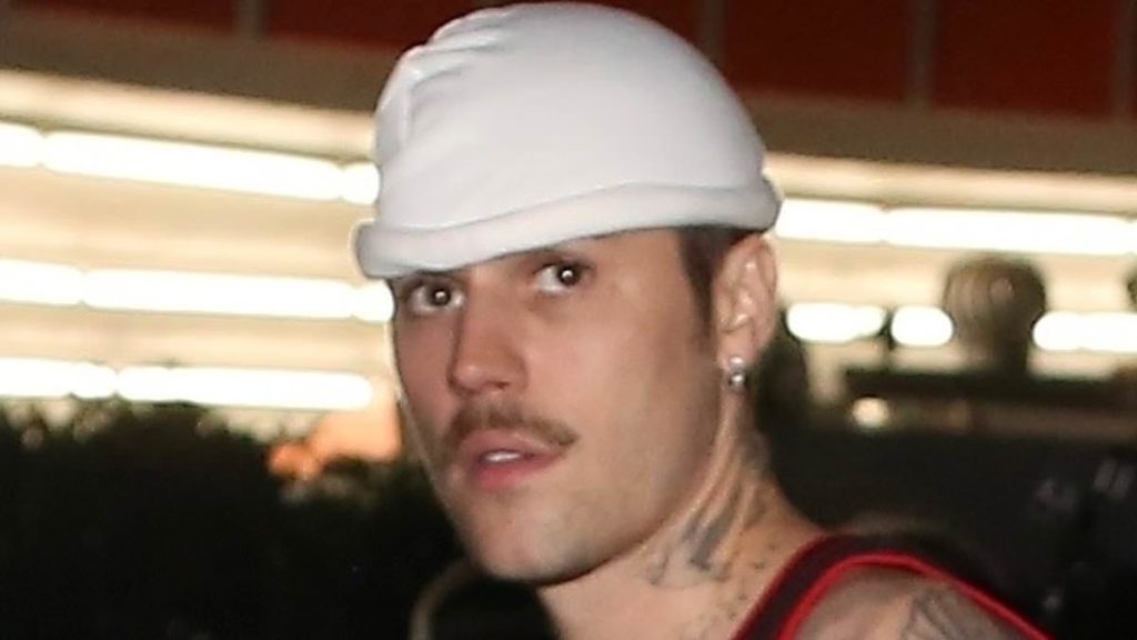 Justin Bieber flashes his tattoos while in a tank top in Beverly Hills
