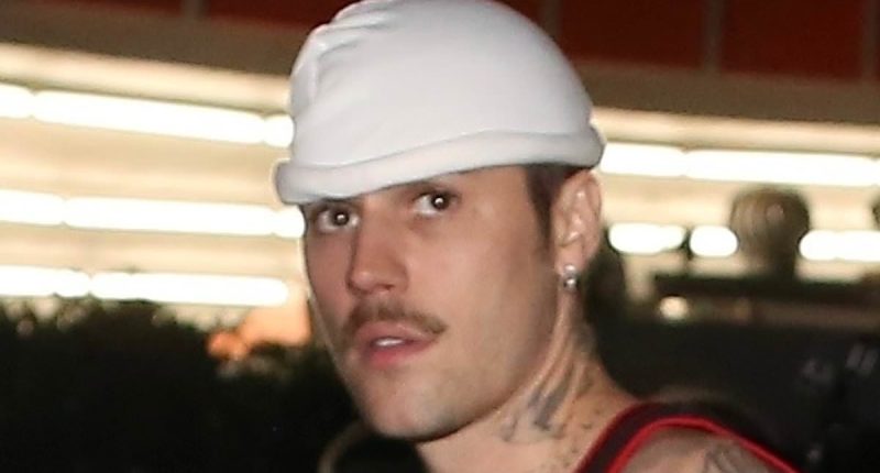 Justin Bieber flashes his tattoos while in a tank top in Beverly Hills