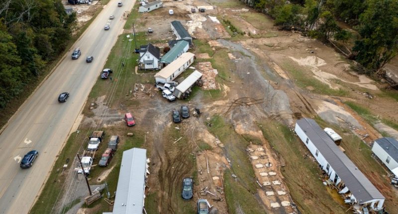 FILE - Homes and vehicles that were damaged in a flood from Hurricane Helene sit on the side of a road near the Swannanoa River, Oct. 1, 2024, in Swannanoa, N.C. (AP Photo/Mike Stewart, File)