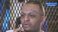 inmates close up with phone to his ear
