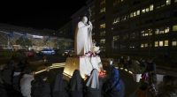 People pray for Pope Francis in front of the Agostino Gemelli Polyclinic, in Rome, Sunday, Feb. 23, 2025, where the Pontiff is hospitalized since Friday, Feb. 14. (AP Photo/Andrew Medichini)