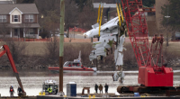 Rescue and salvage crews with cranes pull up the wreckage of an American Airlines jet in the Potomac River from Ronald Reagan Washington National Airport.
