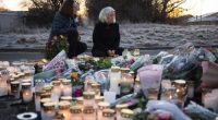People light candles at a makeshift vigil near the scene of the shooting in Sweden on Thursday, February 6. (Jonathan Nackstrand/AFP/Getty Images via CNN Newsource.)