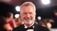 Sam Neill appears in good spirits as he makes rare public appearance following blood cancer diagnosis