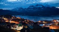 FILE - Homes are illuminated after the sunset in Tasiilaq, Greenland, Friday Aug. 16, 2019. A group of 143 Greenlandic women have sued the Danish state for having been fitted with coils in the 1960s and 1970s, and demand a total compensation of nearly 43 million kroner ($6.3 million), Danish broadcaster DR reported Monday, March 4, 2024.(AP Photo/Felipe Dana, File)