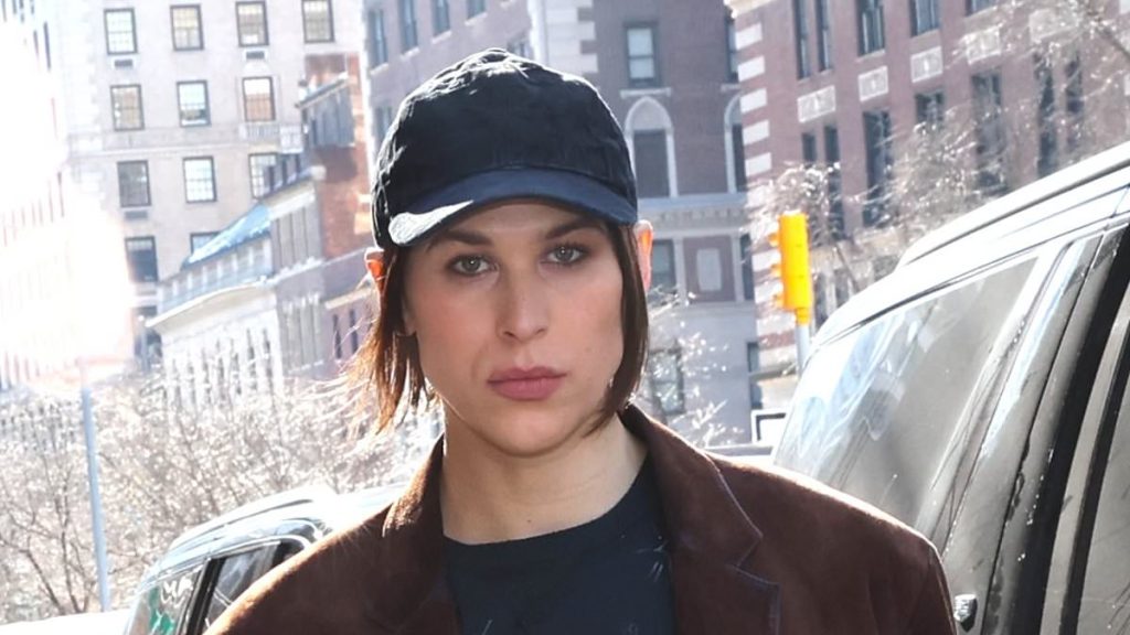 Tommy Dorfman reveals racy thigh tattoo at Coach fashion show in NYC