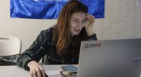 A social worker looks at a laptop with a USAID logo, at a centre for displaced people in Pavlohrad, Ukraine, Saturday, Feb. 1, 2024.