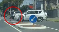 Unbelievable moment an SUV driver mounts a curb to try and mow down a pedestrian on a busy street