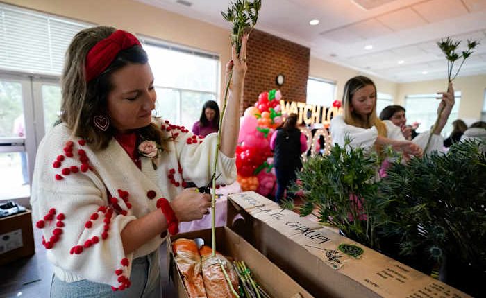 Volunteers deliver gifts to widows on Valentine's Day. The project began in a florist's driveway