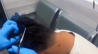 WATCH: Officers cut open man's 'narco wig' at Colombian airport to reveal cocaine