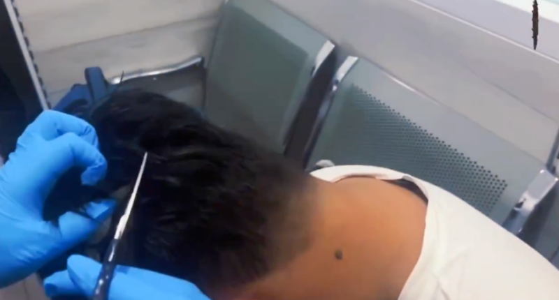 WATCH: Officers cut open man's 'narco wig' at Colombian airport to reveal cocaine