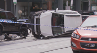 Two teenagers have been arrested after fleeing the scene when a car crashed and rolled on a busy inner-city street in Melbourne.