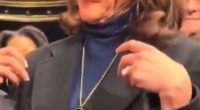 Kamala Harris adjusting her necklace.