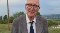 Portrait of a smiling older man wearing glasses.