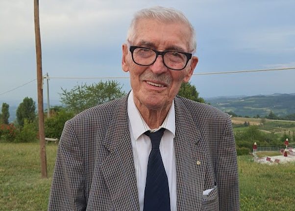 Portrait of a smiling older man wearing glasses.