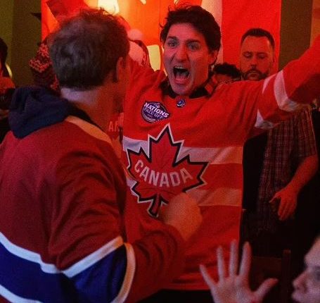Justin Trudeau wearing a Canada hockey jersey and celebrating.