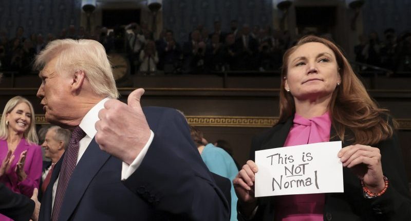 'This is not normal': Who held up the protest sign before Trump's speech?