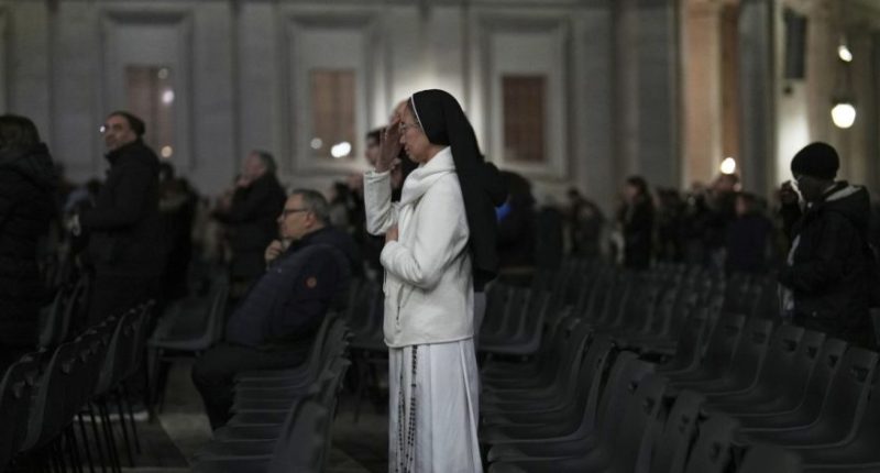 A Catholic nun crosses herself during a prayer of the Rosary for Pope Francis in St. Peter's Square at The Vatican, Sunday, March 9, 2025. (AP Photo/Francisco Seco)