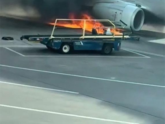 American Airlines plane on fire at an airport.
