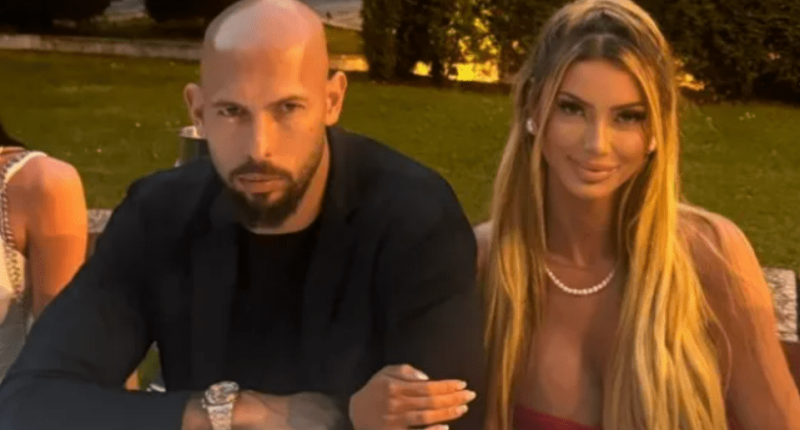 Couple sitting at a table outdoors.