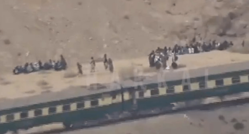Aerial view of people gathered near a train.