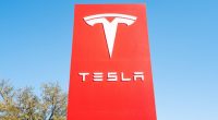 Tesla logo on a red sign.