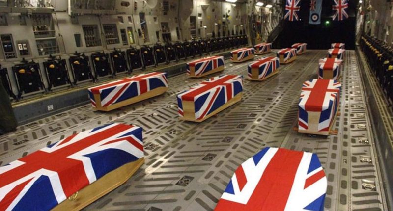 British military caskets draped with Union Jack flags inside a cargo plane.