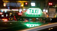 Taxi Parisien sign on a taxi at night.