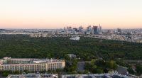 Aerial view of Paris skyline at sunrise, with La Defense in the distance.