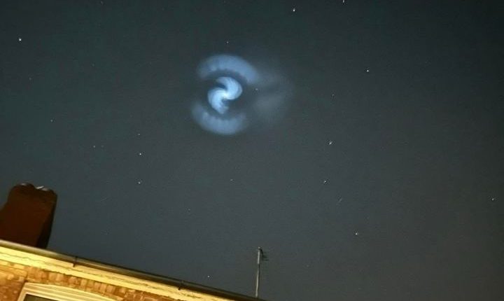 Spiral cloud of illuminated frozen fuel from a SpaceX rocket launch over the UK.
