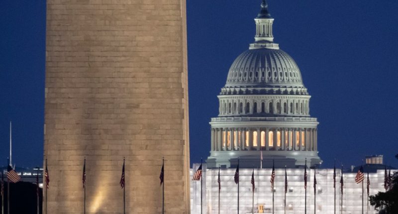 The US Capitol Building and Washington Monument at dusk.