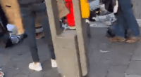 People standing around a paramedic in a red uniform.