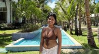 Photo of Sudiksha Konanki in swimwear by a resort pool.