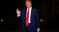 Donald Trump waving upon arrival at the White House.