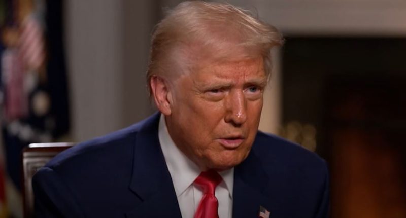 Donald Trump in a blue suit and red tie.