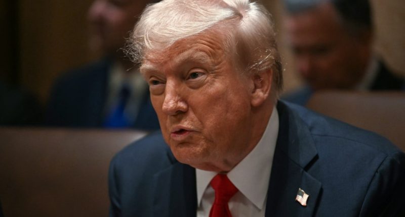 Close-up of Donald Trump speaking at a meeting.