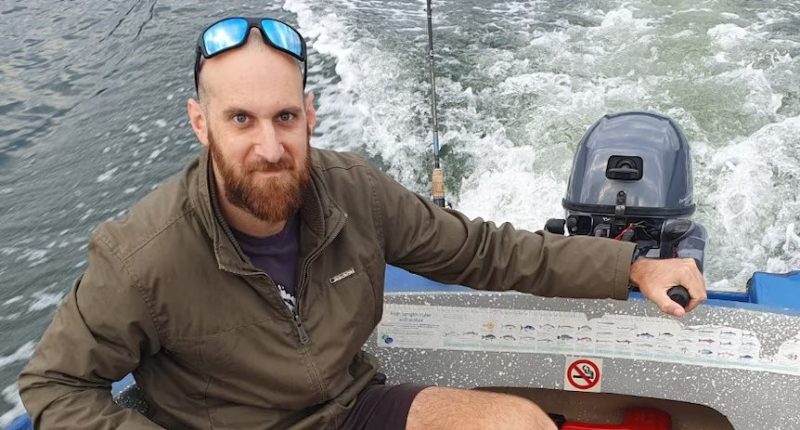 Man in a boat holding the throttle.
