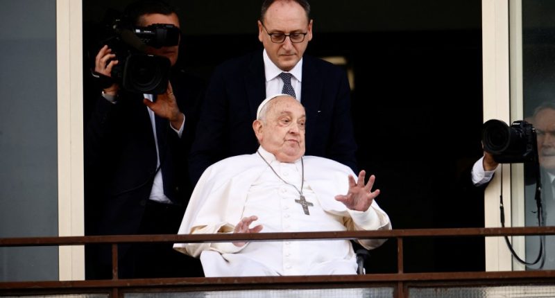 Pope Francis gesturing from a balcony.