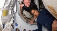 Two astronauts in the International Space Station's vestibule.