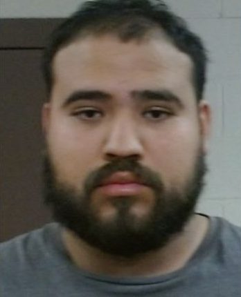 Mugshot of a man with a beard.