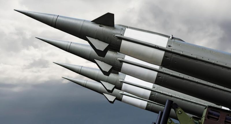 Nuclear missiles aimed at a cloudy sky.