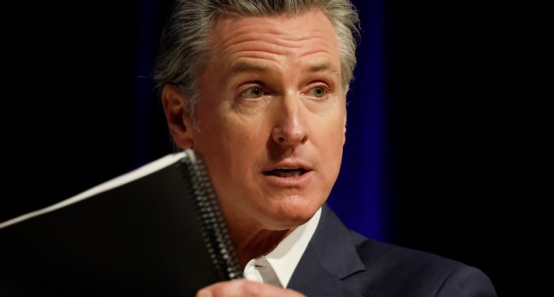 Governor Gavin Newsom speaking at a podium.