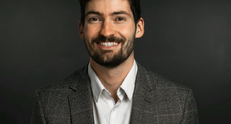 Portrait of a smiling man in a suit.