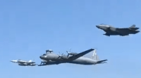Three military aircraft in flight.