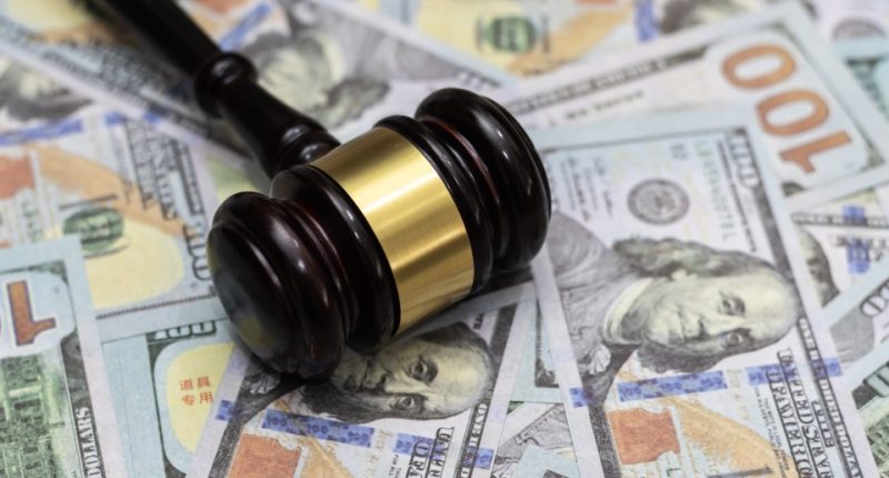 Gavel on top of US dollar bills.