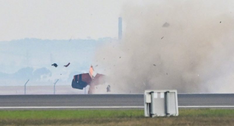 Photo of an airplane crashing at an airshow.